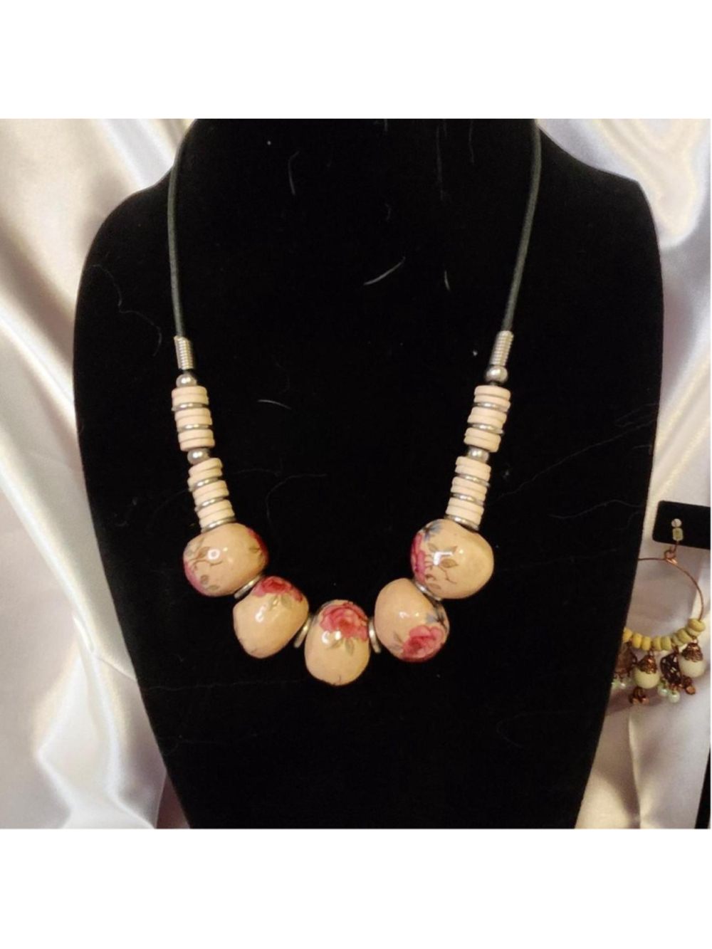 Boho floral necklace with pink and cream beads featuring red floral designs and